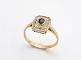 an image of a gold ring with a black diamond