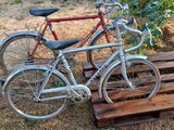 two bikes that are parked on a wooden pallet