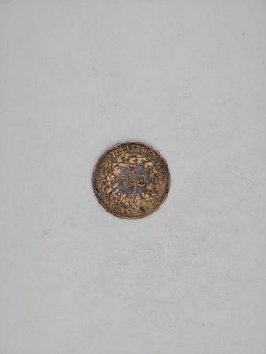a close up of a coin on a white surface with a white background