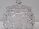 an image of a clear glass jar with a lid on a table