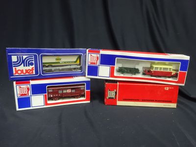 three boxed boxes of toy trains sitting on a black surface