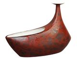 a red vase that is sitting on a white surface