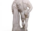 marble statue of a man holding a towel in his right hand