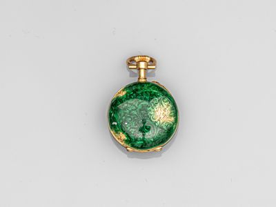 a close up of a green and gold locke on a white surface