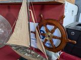 a small sailboat sitting on top of a red table