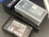 two batteries and a box on the ground next to a box