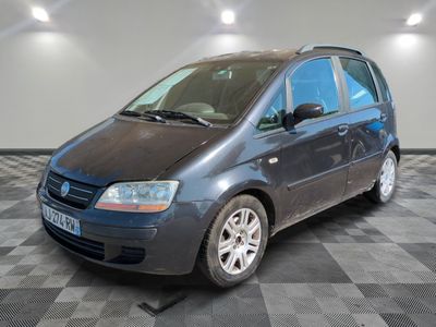 a picture of a small blue car parked in a garage