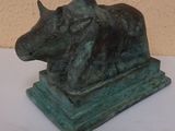 a statue of a bull that is sitting on a table