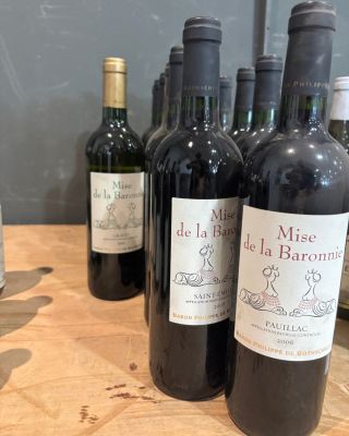 plusieurs bouteilles de vin sont alignées sur une table en bois