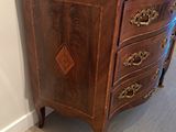 an antique wooden chest of drawers with marble top
