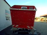 a red container sitting on top of a trailer