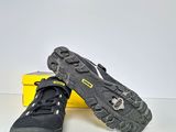 pair of black hiking shoes sitting on top of a yellow box
