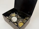 a black box with a watch and other items in it