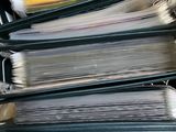 a lot of folders in a box with labels on them
