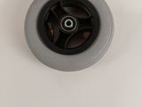 a black wheel on the top of a white sink