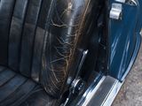 a close up of a car seat with a bag on it