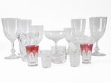 a lot of wine glasses that are sitting on a table