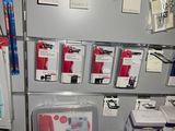 a wall of office supplies on display in a store