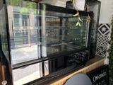 a glass display case with a lot of food inside of it