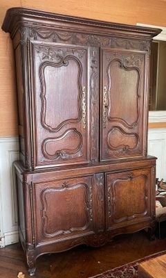 a large wooden cabinet in the corner of a room