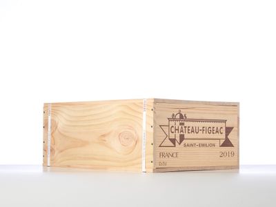 wooden box with a logo on it sitting on top of a table
