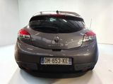 a grey car that is parked in a white room