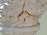 a close up of a statue of a man with a bird on it ' s head