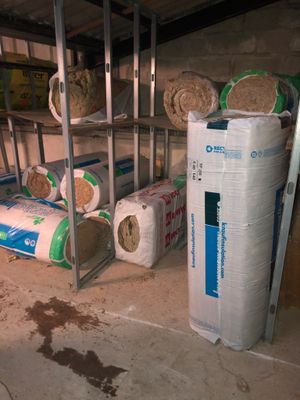 several rolls of toilet paper on a shelf in a room