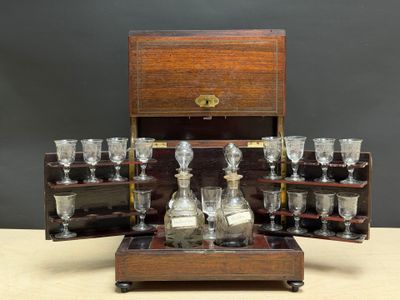 a wooden box with a set of wine glasses and a decanter