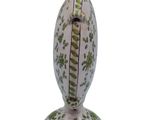 a white vase with green leaves on it on a white background
