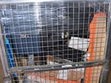 a metal cage filled with various items inside of it