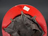 a red bucket with a black cloth inside of it
