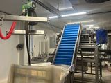 a picture of a factory with a conveyor belt and a conveyor belt
