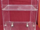 an image of a clear acrylic shelf with wheels