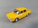 a yellow toy car that is sitting on a gray surface