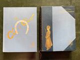two books sitting on top of a table next to each other