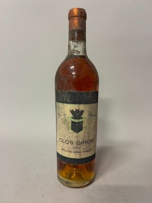 an old bottle of liquor sitting on top of a white table
