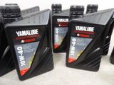 four bottles of motor oil are lined up on a table