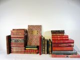 many books stacked on top of each other on a table