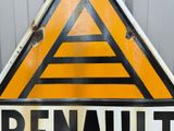 a sign that says renault on it in front of a building