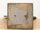 a metal box with a hole in it sitting on a table