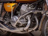 a close up of a yellow motorcycle parked on the street