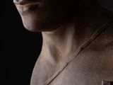 statue of a man with a bandage on his chest