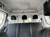 two seats in the back of a van with a television on