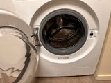 a white washing machine with a glass bowl next to it