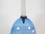a blue glass vase with a gold horn on top of it