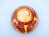 overhead view of a bowl of food on a blue surface