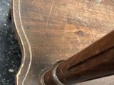 a close up of a wooden chair with a wooden handle