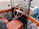 a car with a steering wheel and a leather seat