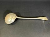 a spoon and a spoon rest on a table